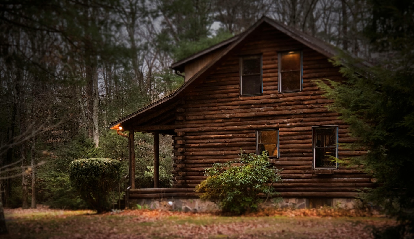 Personal Retreat hero image; picture of a remote, idyllic cabin in the woods